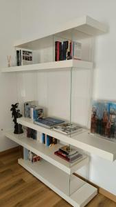 a white book shelf filled with books at the apARTment in Lanciano