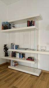 a white book shelf with books on it at the apARTment in Lanciano