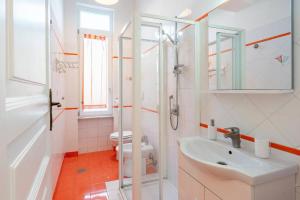 a white bathroom with a sink and a toilet at Beatrice Room Bed&Breakfast in Sant'Agnello