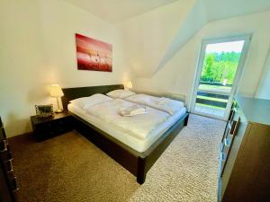 A bed or beds in a room at Mezonet Tatry