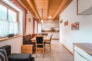 a kitchen and dining room with a table and chairs at ALMRESIDENZ UNTERRAIN - with FREE SKI BUS SHUTTLE in Valdaora