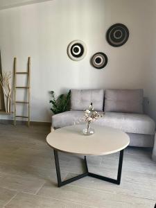 a living room with a table and a couch at Αura Luxury Apartments in Ierissos