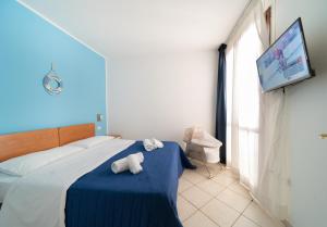 a bedroom with a bed with two stuffed animals on it at Residence Alessandra in Cesenatico