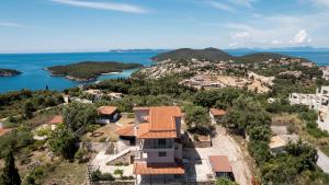 an aerial view of a house on a hill next to the water at ArtView Villa in Syvota