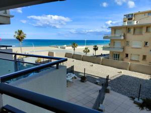 a view of the beach from the balcony of a building at Studio cosy vue mer Canet Plage 3étoiles in Canet-en-Roussillon