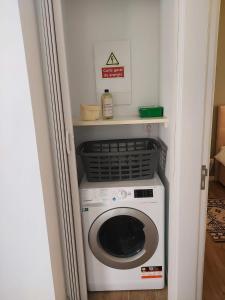 a washer and dryer sitting in a room at Casa da Vila in Velas +3 photos