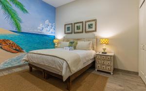 a bedroom with a bed with a painting on the wall at Palacio Blanco Luxury Villa 3 in La Ventana