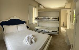 a bedroom with two beds with white sheets and towels at b&b Giorgia in Tropea
