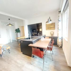 a kitchen and dining room with a table and chairs at New Charming Grand Place Apartment in Brussels