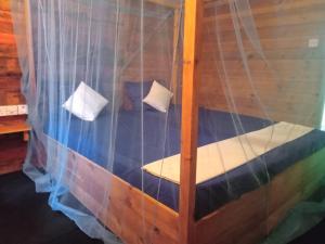 a wooden bunk bed with two pillows on it at Silaa Cabana in Trincomalee