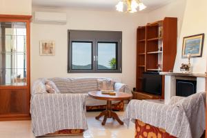 a living room with a couch and a table at ArtView Villa in Syvota