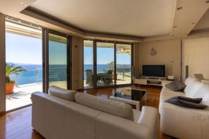 a living room with a couch and a television at Luxury condo with fantastic view and private pool in Komoševina