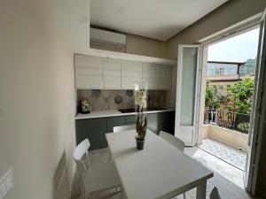 a kitchen with a table with a vase of flowers on it at b&b Giorgia in Tropea