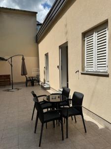 a patio with a table and chairs and a building at Apartments Ascic in Opatija +3 photos