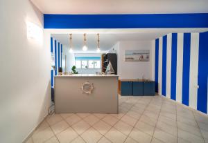 a kitchen with blue and white walls and a counter at Residence Alessandra in Cesenatico