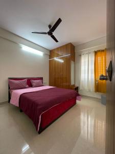 a bedroom with a bed with a ceiling fan at HSR Lodestone by Newstays in Bengaluru