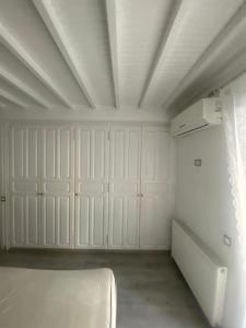 a room with white cabinets and a bed in it at Beautiful apartment in Mykonos town ! in Mýkonos City