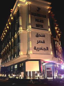 um edifício com uma placa ao lado à noite em Al jadriya Palace em Al Karrādah
