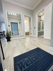 a large living room with a black rug on the floor at Central Beautiful Apartment with Parking in Chişinău +73 photos