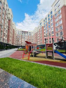 a playground in front of a large building at Central Beautiful Apartment with Parking in Chişinău