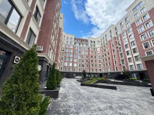a large building with christmas trees in front of it at Central Beautiful Apartment with Parking in Chişinău