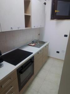 a kitchen with a sink and a stove at Casa Materdomini in Brindisi