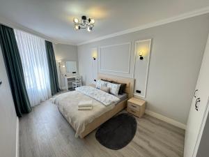 a bedroom with a bed and a chandelier at Central Beautiful Apartment with Parking in Chişinău