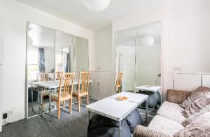 a living room with a couch and a table at City center spacious bedrooms in Kent