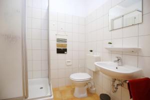a white bathroom with a toilet and a sink at Ostseeliebe - Sünnenkieker WE7, Beckerwitz in Beckerwitz +32 photos