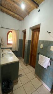 a bathroom with a sink and a mirror at Capec Alojamiento in Tilcara