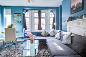 un soggiorno con pareti blu e divano di Dubai Media City Convenient Apartments a Dubai