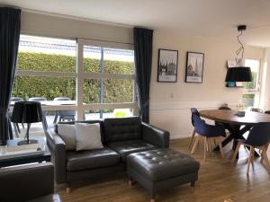 a living room with a couch and a table at Villa Overstag in Terherne