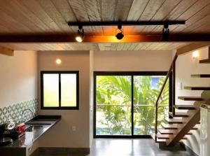 a kitchen with a spiral staircase in a house at Flat Camburi in Camburi