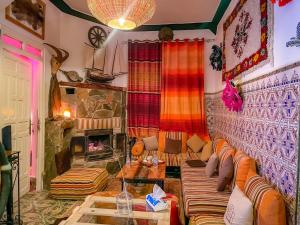 a living room with a couch and a fireplace at Atlas Room in Midelt
