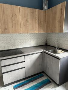 a kitchen with a sink and a counter top at AppArt 24 city center parking and Sea in Lignano Sabbiadoro