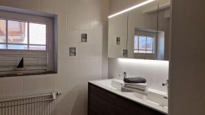 a bathroom with a sink and a mirror at Ferienhaus im Moor in Wiesmoor +32 photos