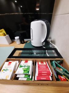a coffee maker sitting on top of a table with books at Apartman AE in Mostar +4 photos