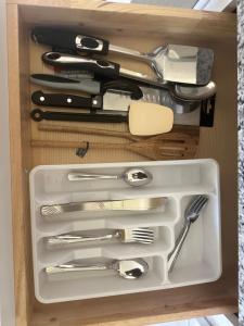 a drawer full of utensils in a drawer at Cozy Modern Retreat, Comfortable and Spacious in Glenn Heights