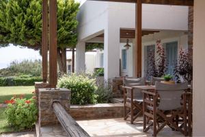 patio con tavolo e sedie sotto ombrellone di BATIS Beach House a Kipri