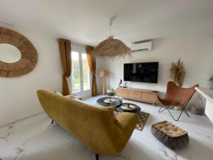 a living room with a couch and a table at Le Val d'escure in Saint-Raphaël