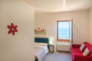 a bedroom with a bed and a window at Studio apartment in the Castle Castelsardo in Castelsardo