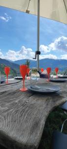 a wooden table with red wine glasses on it at Maison pour des vacances in Ayent