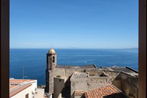 a view from the city of dubrovnik with a clock tower at Studio apartment in the Castle Castelsardo in Castelsardo