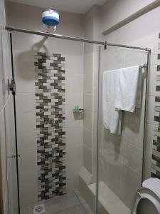 a bathroom with a shower with a glass door at Sparkle Homes in Nairobi
