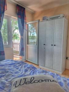 a bedroom with a bed and a balcony at Vila Marina in Kovin