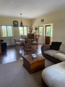 a living room with a couch and a table at The Ranch in Leitrim