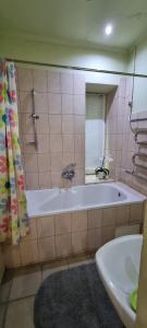 y baño con bañera, lavabo y espejo. en Софиевская 8, en Kiev