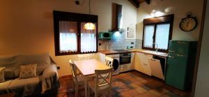 a kitchen with a couch and a table in a kitchen at Cueva les Pedroses in Ribadesella