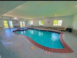 a large swimming pool in a large building at Crystal Suites in Texas City