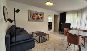a living room with a couch and a table at Moderne Gästesuite in Lucerne +14 photos